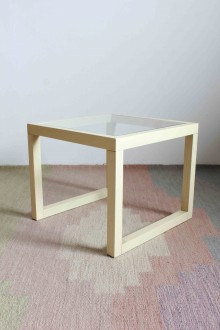 Cube-shaped coffee table with glass top and open-pore stained wood structure